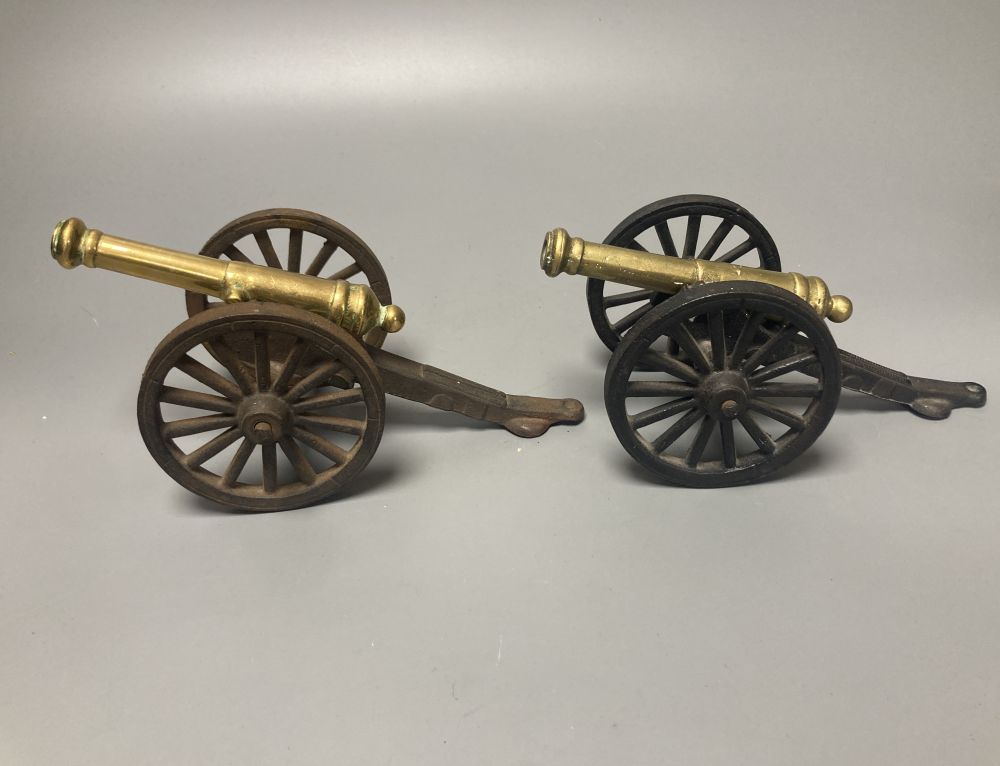 A large bronze mortar and pestle, bearing mock date 1630, 25cm diameter, and two iron and brass canon models